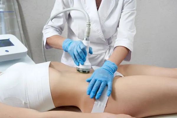 Lost the Weight but Not the Loose Skin? 2 woman having HIFU treatment on her stomach to combat loose skin Beaconsfield following weight loss